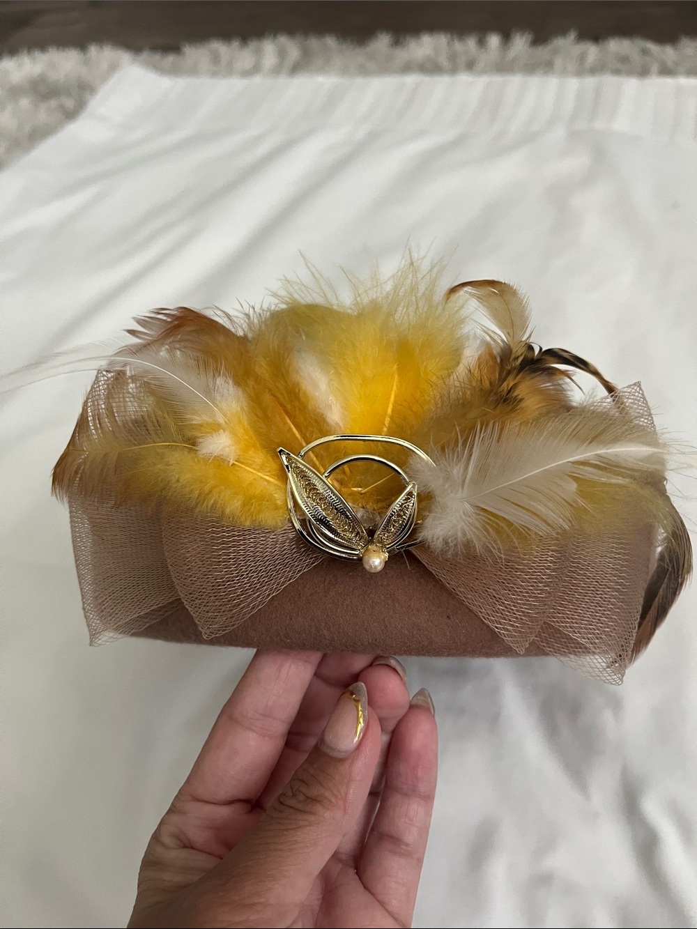 Elegant Brown Headband with Yellow Feather Accent and Gold Leaf Detail